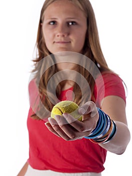 Young teenage girl holding a tennis ball (focus on the ball)