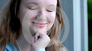 young teenage girl leaning on arm sad thoughtfully thinking smiling holding simple pencil in hands thinking coming up