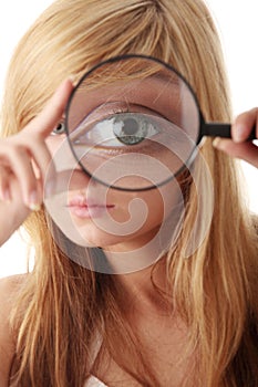 Young teenage girl with magnifier