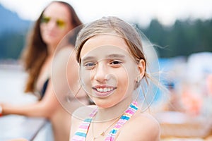 Young teenage girl with mother at summer resort