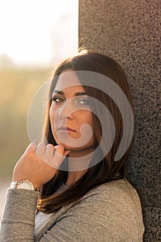 Young teenage girl portrait headshot against wall with serious look