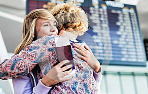 Young teenage girl reuniting with her mother in airport