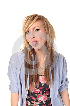 Young teenage girl sticking out tongue