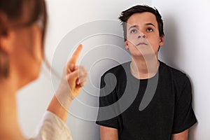 Young teenager boy bored by the constant lecturing and confrontation with his mother