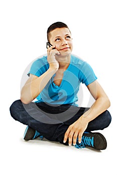 A young teenager boy on the cell phone looking up