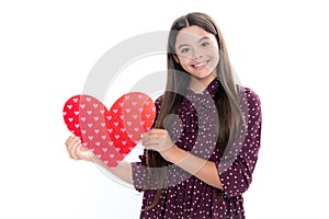 Young teenager child girl with heart shape. Happy Valentines Day. Love and pleasant feelings concept. Portrait of happy