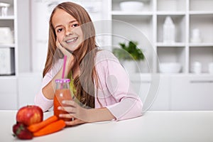 Young teenager girl enjoy a fruit juice in the kitchen