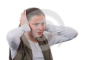 Young teenager girl with hands covering his ears not to hear noise.