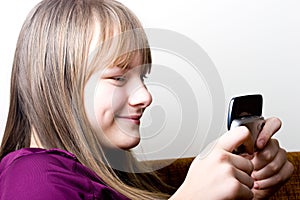 Young teenager girl holding mobile phone texting