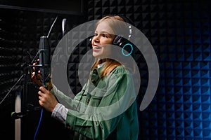 Young teenager girl singer at record studio