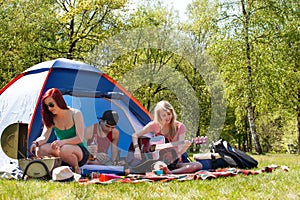 Young teenagers having a nice time on the camping