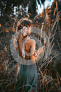 Young and tender woman on a feild at sunset portrait