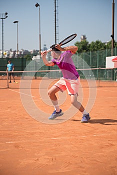 Young tennis player prepares for playing backhand