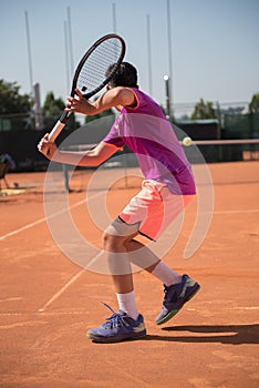 Young tennis player prepares for playing backhand