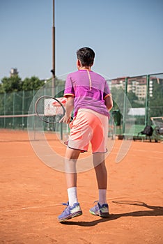 Young tennis player prepares for receiving the servis. High concentration.
