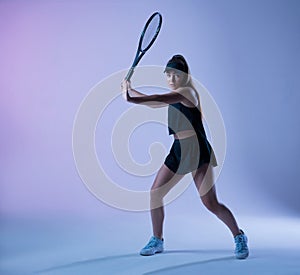 Young tennis player preparing to make forehand shot