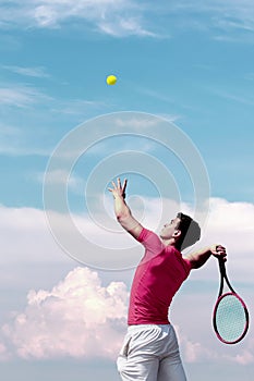 Young tennis player teen with racket hits flying ball in jump. Cute male tennis player athlete in action. Copy space