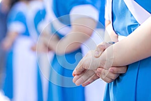 Young Thai female nursing students cross their arms behind their backs and stand