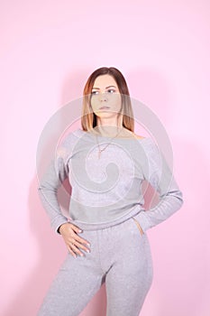 young thin girl in a knitted suit on a light background. Tenderness, femininity.