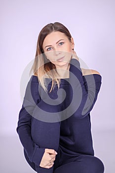 young thin girl in a knitted suit on a light background. Tenderness, femininity.