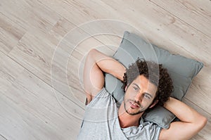 Young Thinking Man Lying On Floor photo