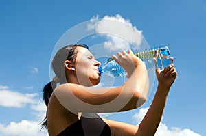 Young thirsty girl drinking water