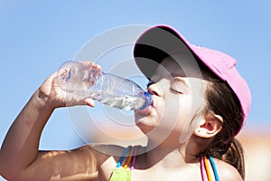 Young girl drinking water photo