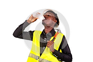 Young thirsty technician man drinking water bottle