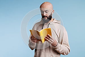 Young thoughtful arab man reading book