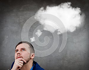 Young thoughtful businessman with white cloud over head.