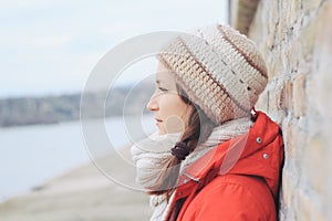 Young thoughtful lonely woman in winter clothes