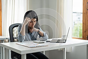 Young tired stressed overworked businesswoman freelancer exhausted after hard work, suffering from migraine headache at