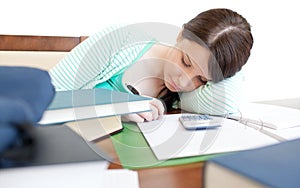 Young tired woman studying on a table