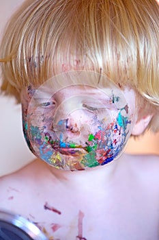 Young toddler covered in face paint