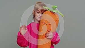 Young toddler school girl kid smiling friendly gesturing hello or goodbye, welcoming, waving hands