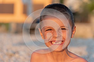 Young toothless boy at the beach