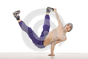 Young topless man sitting on one hand in streetdance position ho