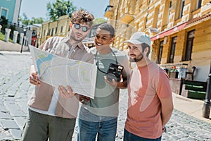 young tour guide in sunglasses showing
