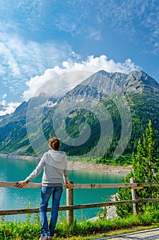 Young tourist azure mountain lake in Alps, Austria