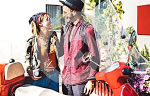 Young tourist couple having fun together at scooter moped ride - Hipster guy having fun outdoors