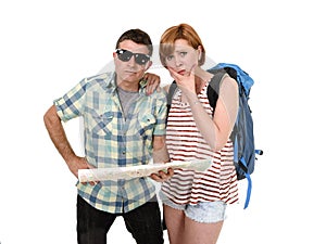 Young tourist couple reading city map looking lost and confused loosing orientation with girl carrying travel backpack