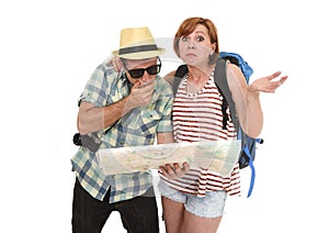 Young tourist couple reading city map looking lost and confused loosing orientation with girl carrying travel backpack