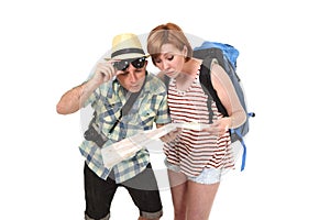 Young tourist couple reading city map looking lost and confused loosing orientation with girl carrying travel backpack