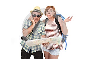 Young tourist couple reading city map looking lost and confused loosing orientation with girl carrying travel backpack