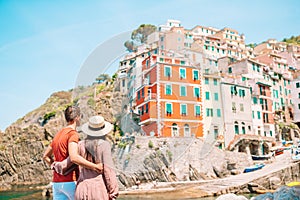 Young tourist couple traveling on european holidays outdoors in italian vacation in Cinque Terre