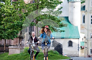 Young tourist couple travellers with electric scooters in small town.