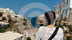 Young tourist girl admiring the beach in Pogliniano al Mare,coast in Bari, Italy