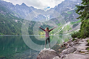 Young tourist girl on Lake Morskie Oko Sea Eye, Zakopane, Poland, High Tatras