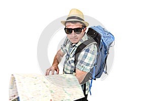 Young tourist man reading city map looking lost and confused loosing orientation carrying backpack