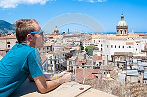 Young tourist observes the city of Palermo from above